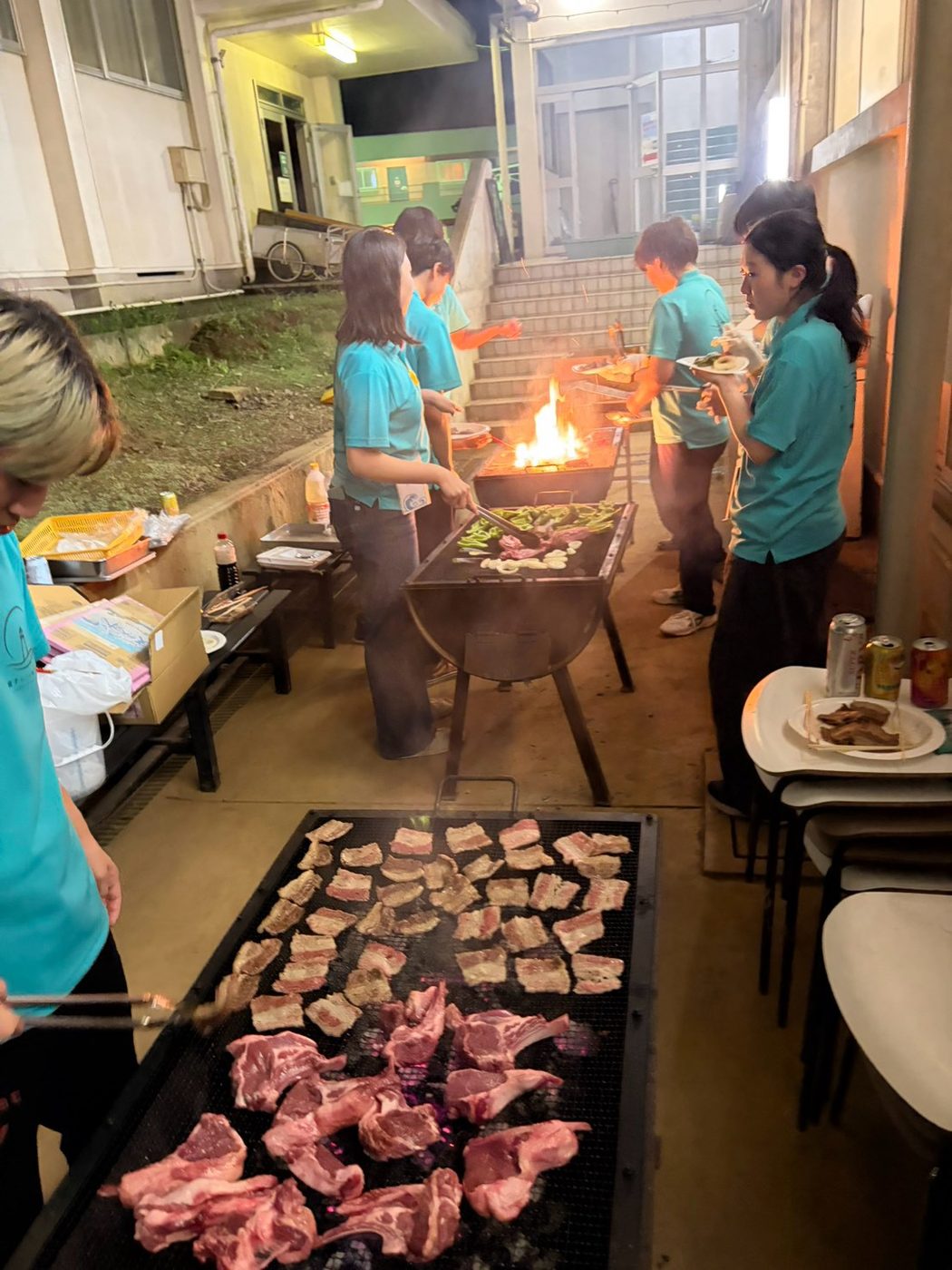 Students at the charcoal grill
